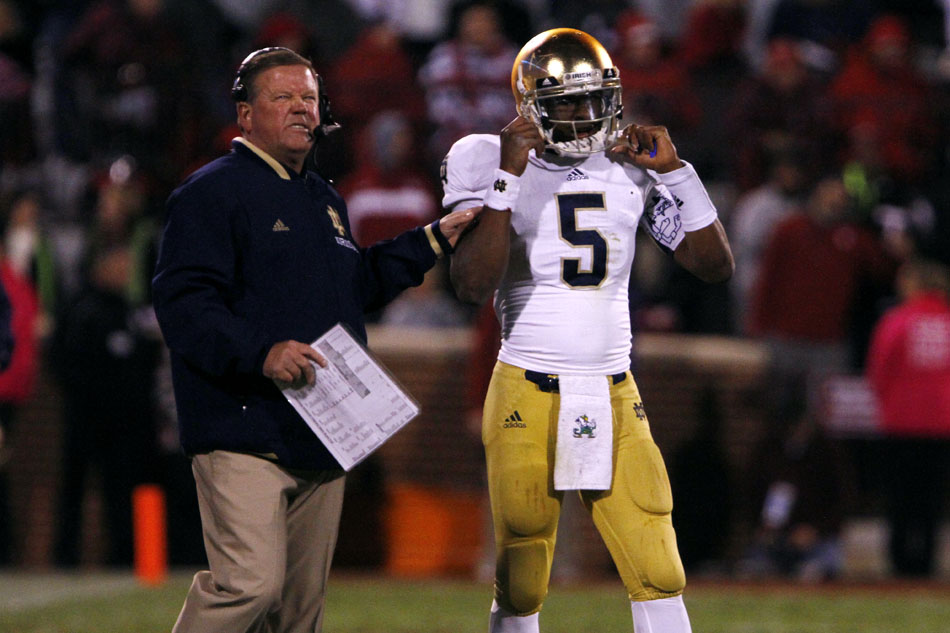 Notre Dame head coach Brian Kelly talks with quarterback Everett Golson (5) during an NCAA college football game on Saturday, Oct. 27, 2012, in Norman, Okla. (James Brosher/South Bend Tribune)