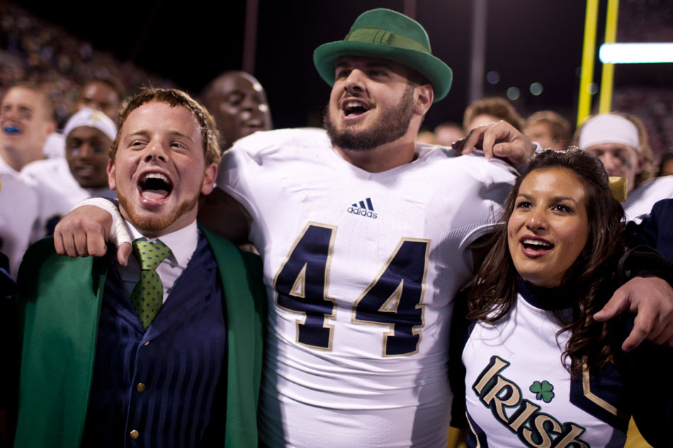 Notre Dame linebacker Carlo Calabrese (44) sings the alma mater with the Notre Dame leprechaun's hat on Saturday, Oct. 27, 2012, in Norman, Okla. (James Brosher/South Bend Tribune)