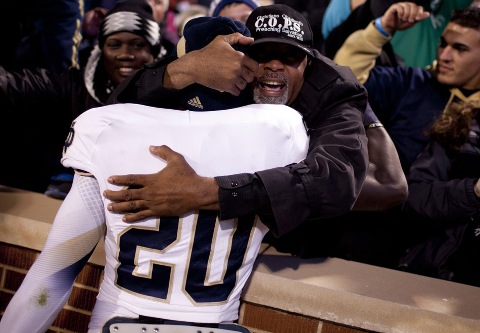 Notre Dame running back Cierre Wood (20) gets a hug after a 30-13 win against Oklahoma on Saturday, Oct. 27, 2012, in Norman, Okla. (James Brosher/South Bend Tribune)