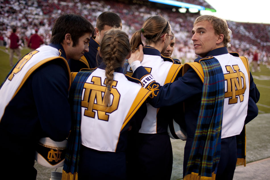 Notre Dame band members huddle on the sidelines before an NCAA college football game on Saturday, Oct. 27, 2012, in Norman, Okla. (James Brosher/South Bend Tribune)