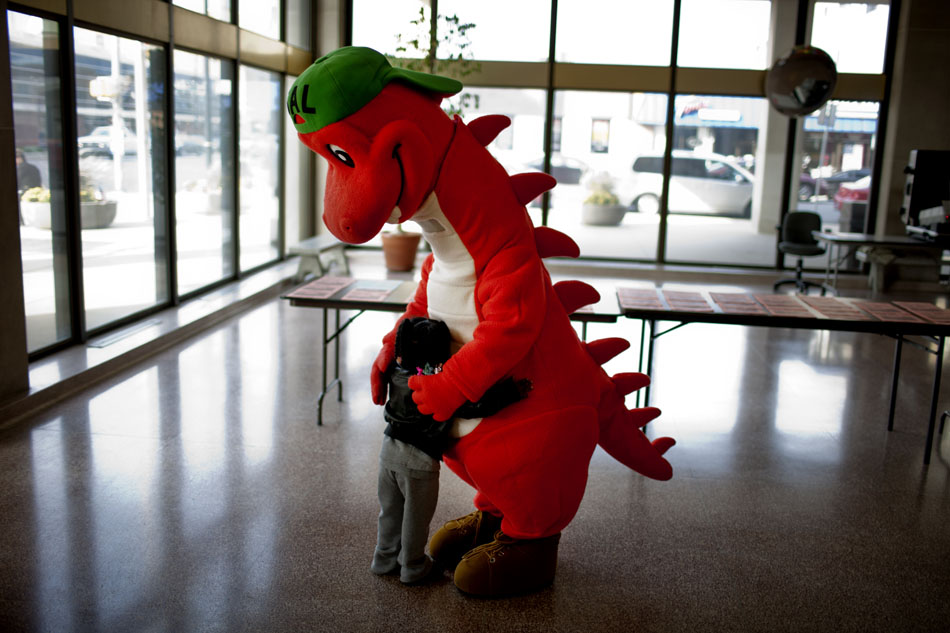 Dimayah Marsh, 3, gets a hug from Sal, a dinosaur mascot promoting lead poisoning awareness, on Monday, Oct. 22, 2012, morning in the lobby of the County-City Building in downtown South Bend. As part of National Lead Poisoning Awareness Week, the St. Joseph County Health Department was offering free lead tests to youngsters inside the lobby of the building. (James Brosher/South Bend Tribune)