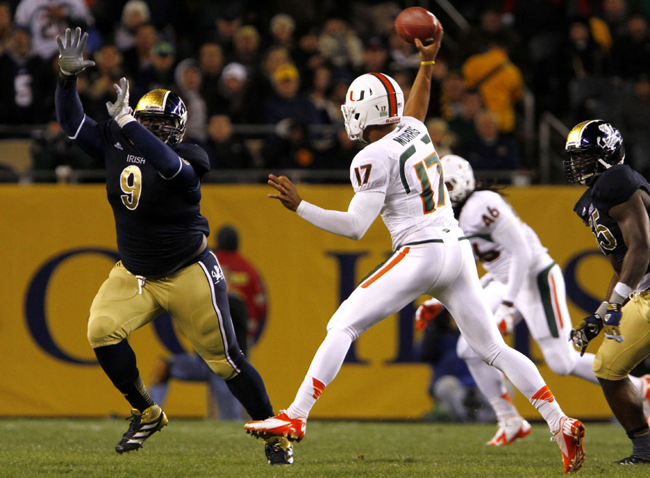 Miami quarterback Stephen Morris (17) looks to pass in front of Notre Dame defensive lineman Louis Nix III (9) during a NCAA college football game on Saturday, Oct. 6, 2012, at Soldier Field in Chicago. (James Brosher/South Bend Tribune)