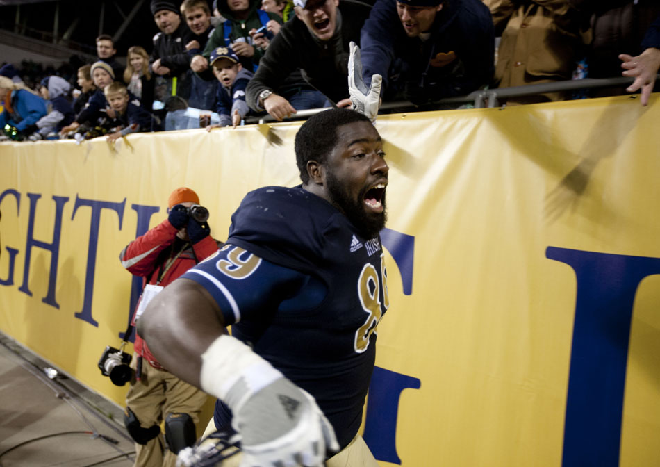 Notre Dame defensive end Kapron Lewis-Moore celebrates with fans following a 41-3 win against Miami on Saturday, Oct. 6, 2012, at Soldier Field in Chicago. (James Brosher/South Bend Tribune)
