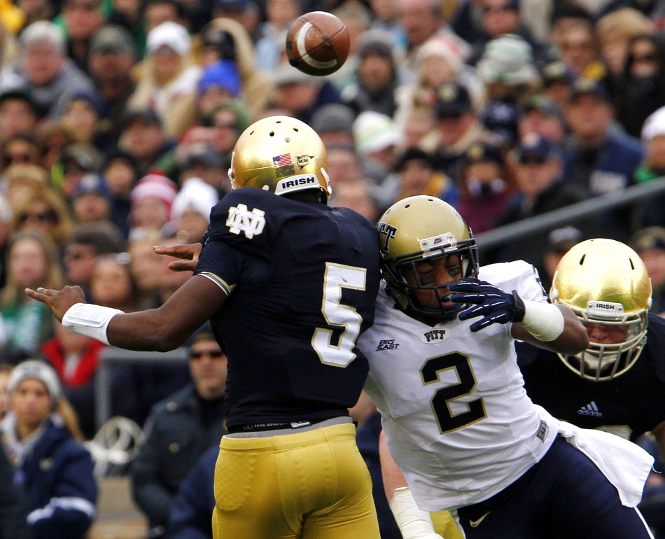Pittsburgh defensive back K'Waun Williams (2) hits Notre Dame quarterback Everett Golson (5) as Golson releases the ball during an NCAA college football game on Saturday, Nov. 3, 2012, at Notre Dame. (James Brosher/South Bend Tribune)