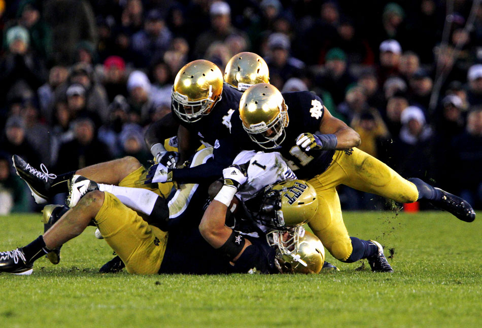 Notre Dame players wrap up Pittsburgh running back Ray Graham during an NCAA college football game on Saturday, Nov. 3, 2012, at Notre Dame. (James Brosher/South Bend Tribune)