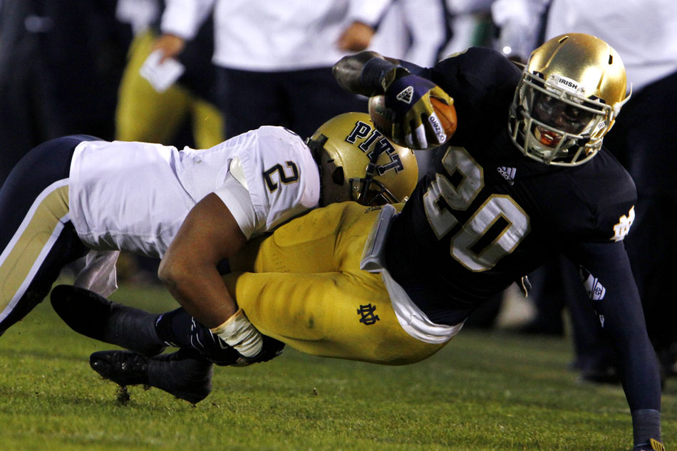 Pittsburgh defensive back K'Waun Williams (2) tackles Notre Dame running back Cierre Wood (20) during an NCAA college football game on Saturday, Nov. 3, 2012, at Notre Dame. (James Brosher/South Bend Tribune)