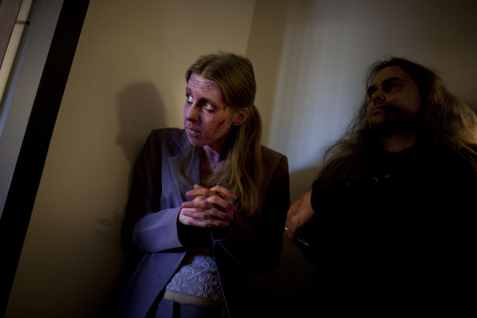 Zombie actress Stephanie Campbell, left, peers into a conference room as a scene is filmed during a promotional video shoot on Wednesday, Dec. 5, 2012, at the WNIT studios in downtown South Bend. (James Brosher/South Bend Tribune)