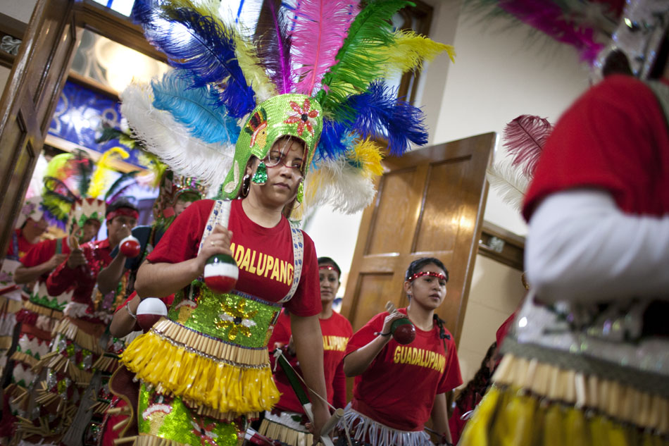 Matachines dancers from Elkhart and Goshen enter the church during a performance on Wednesday, Dec. 12, 2012, at St. Adalbert Parish in South Bend. (James Brosher/South Bend Tribune)