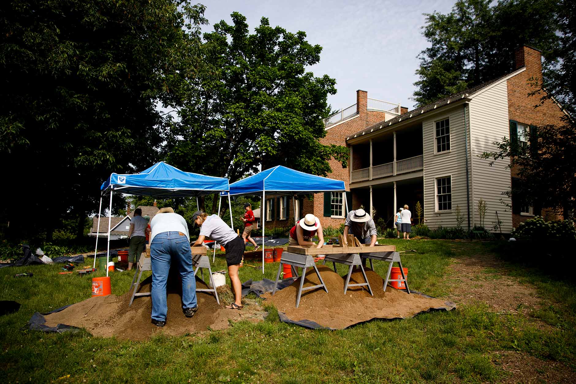 Students work with researchers from the Glenn A. Black Laboratory of Archaeology on the front lawn of Wylie House in Bloomington on Thursday, June 7, 2018. (James Brosher/IU Communications)