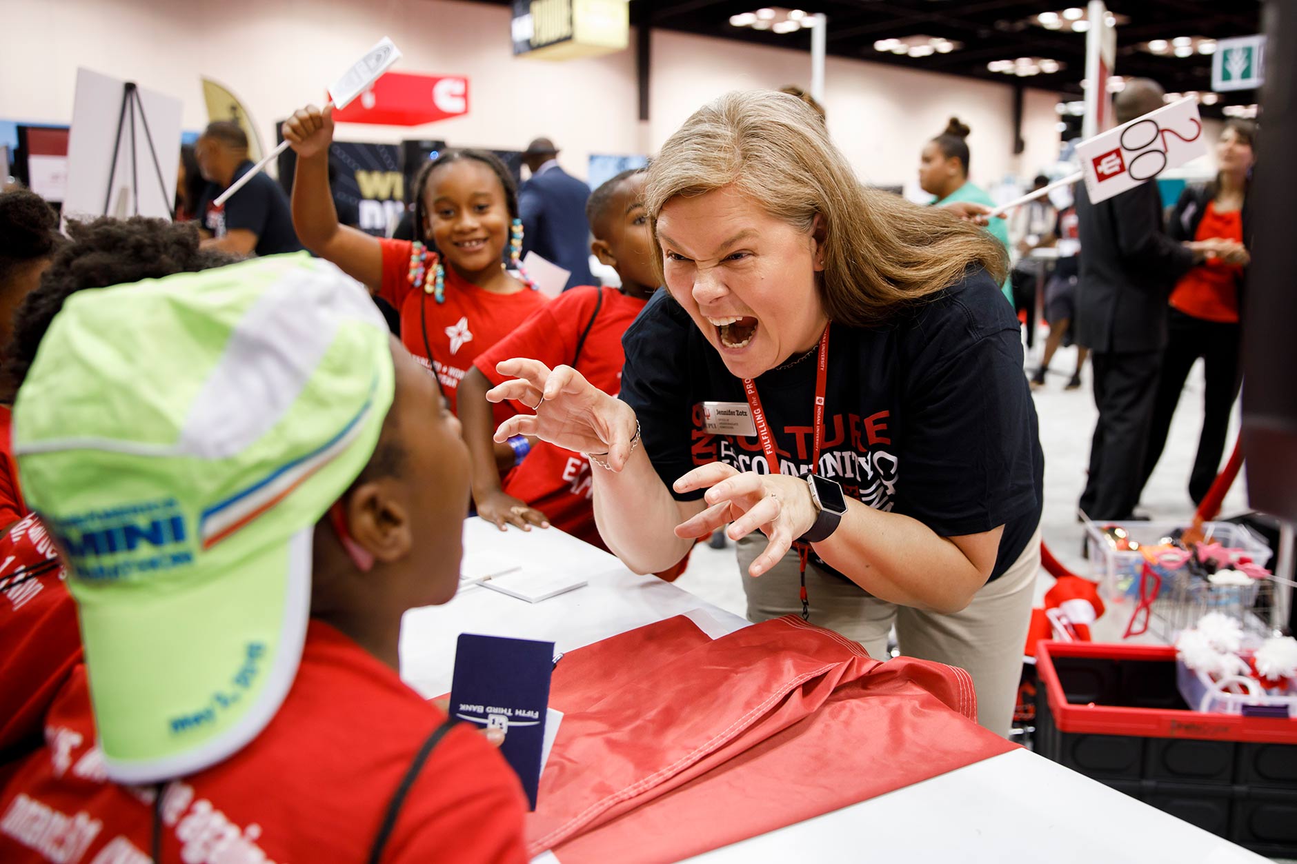 IUPUI Undergraduate Admissions Senior Coordinator Jennifer Zotz gives an IUPUI Jaguar roar to a youngster at the IU booth during Indiana Black Expo's 48th Summer Celebration in Indianapolis on Friday, July 20, 2018. (James Brosher/IU Communications)