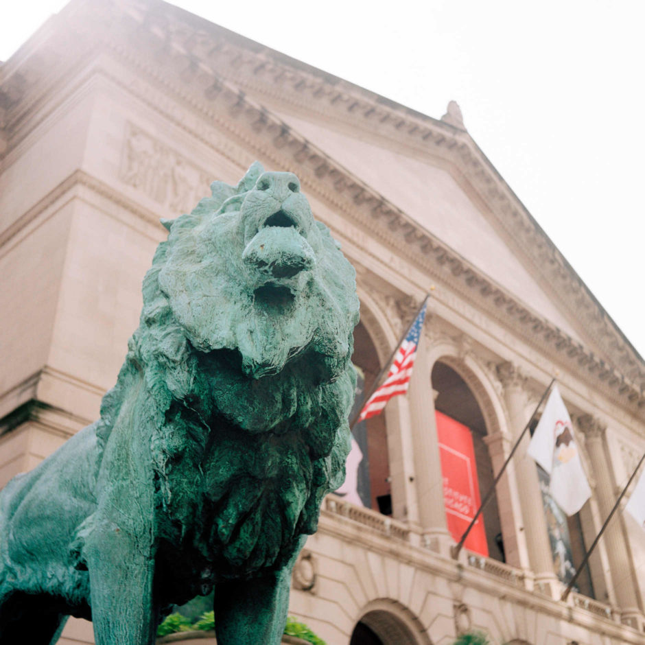A sculpture of a lion by Edward Kemeys guards the entrance to the Art Institute of Chicago on Sunday, July 1, 2018. (Photo by James Brosher)