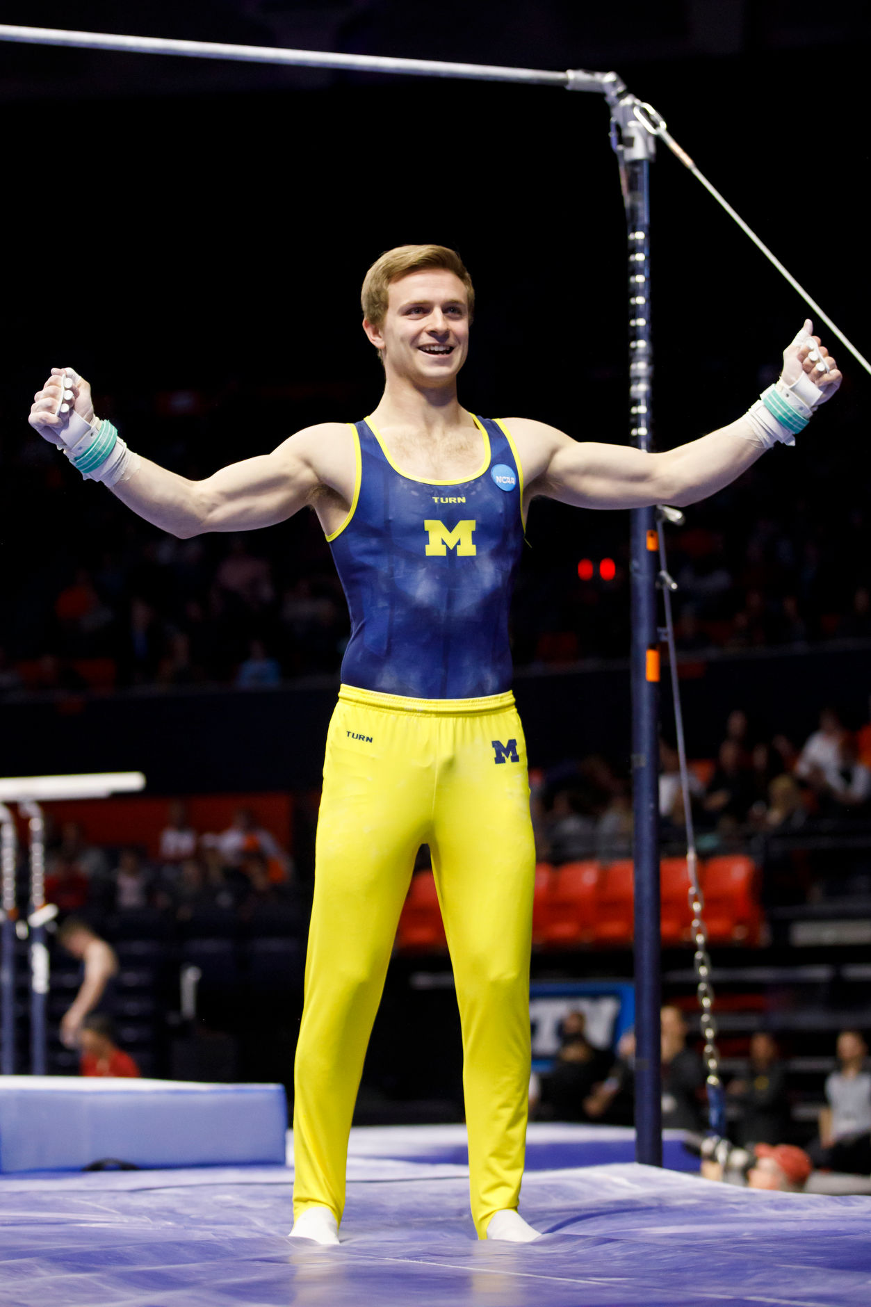 Michigan's Alec Krystek reacts after competing on the horizontal bar at the NCAA Men's Gymnastics Championships on Saturday, April 20, 2019, at the State Farm Center in Champaign, Illinois. (Photo by James Brosher)