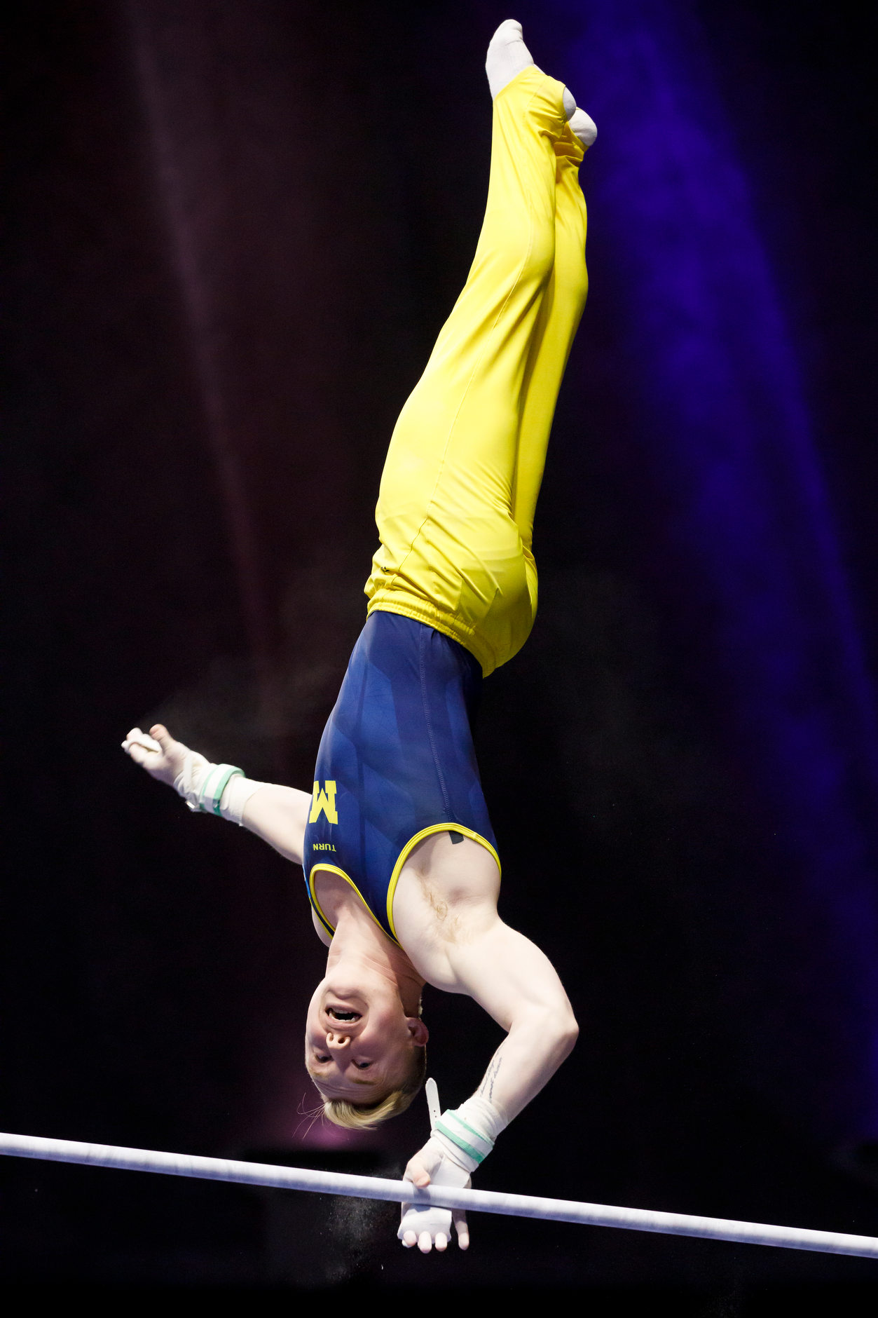 Michigan's Cameron Bock competes on the horizontal bar at the NCAA Men's Gymnastics Championships on Saturday, April 20, 2019, at the State Farm Center in Champaign, Illinois. (Photo by James Brosher)