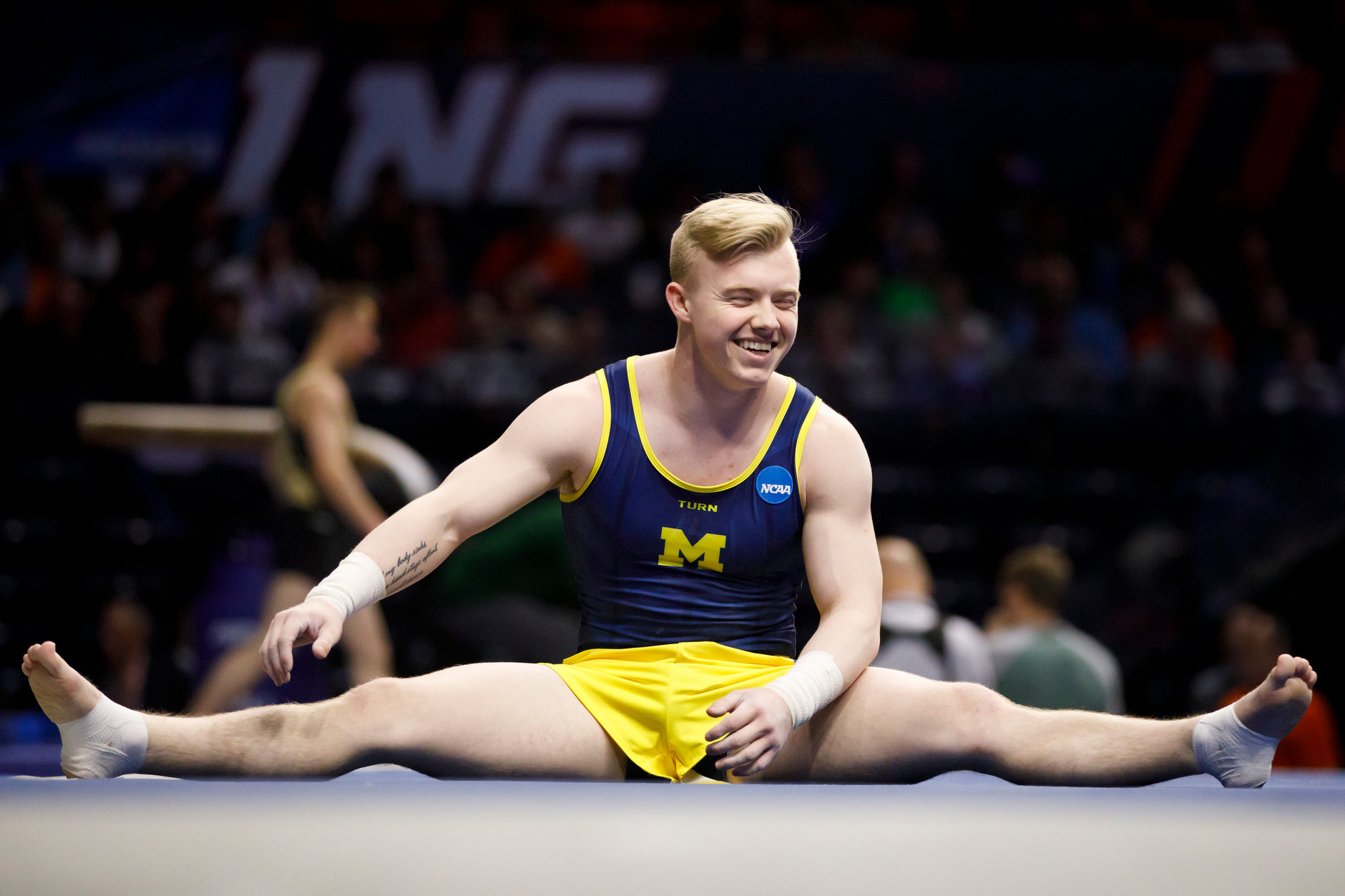 Michigan's Cameron Bock warms up before the floor exercise at the NCAA Men's Gymnastics Championships on Saturday, April 20, 2019, at the State Farm Center in Champaign, Illinois. (Photo by James Brosher)