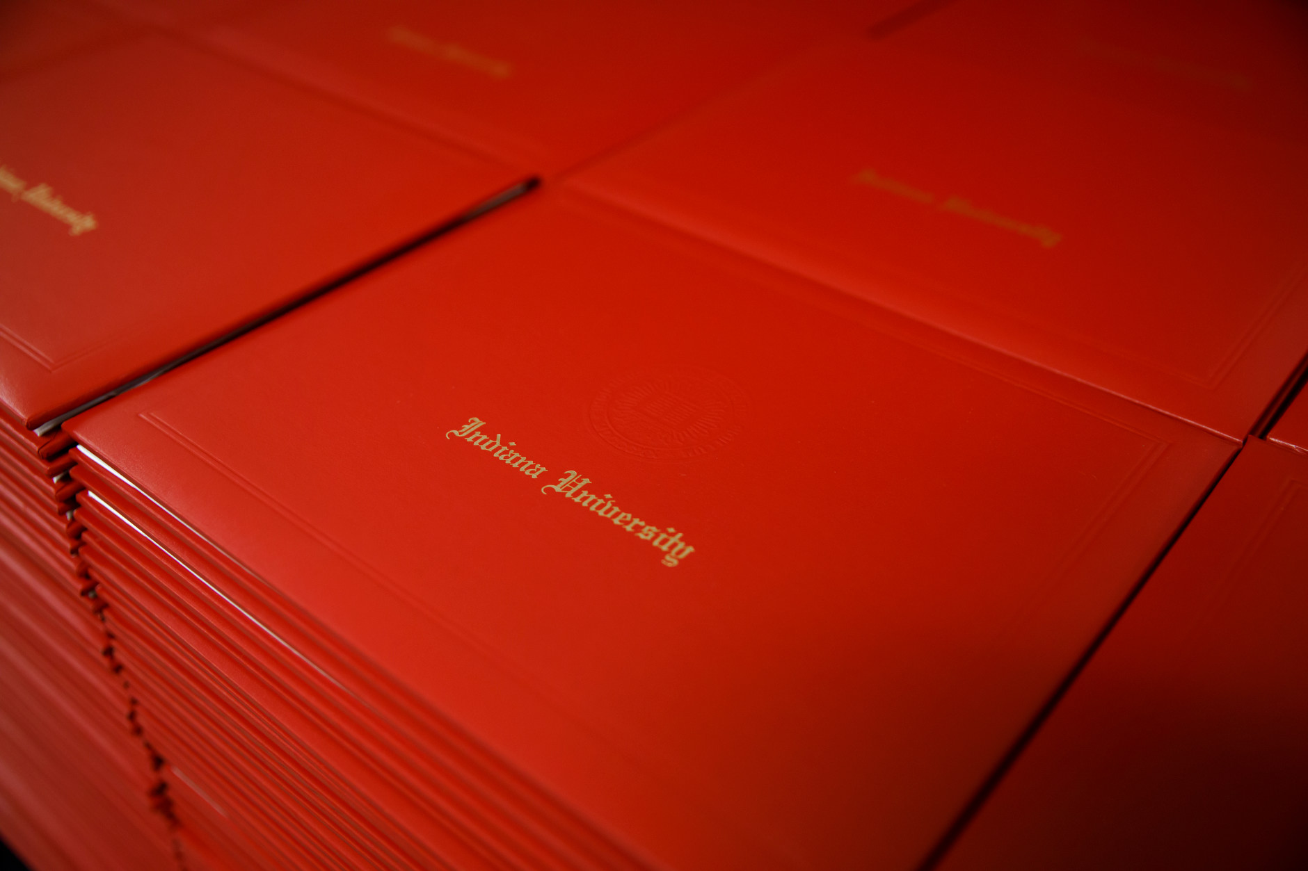 Indiana University diplomas sit in a stack before the start of the IU Bloomington Graduate Commencement at Assembly Hall on Friday, May 3, 2019. (James Brosher/Indiana University)