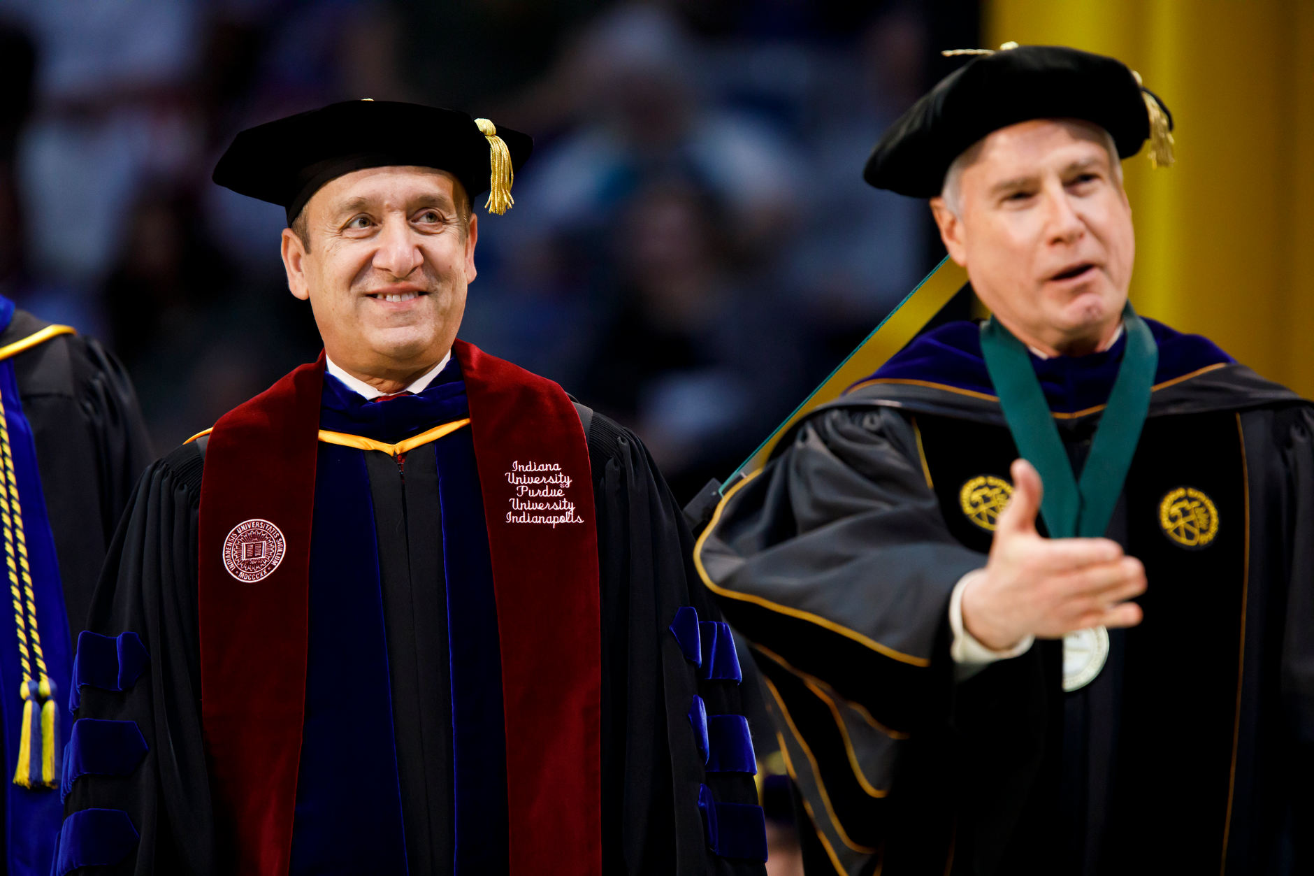 Indiana University Executive Vice President and IUPUI Chancellor Nasser H. Paydar smiles as he greets graduates on stage during the Purdue Fort Wayne and IU Fort Wayne Commencement at the Allen County War Memorial Coliseum on Wednesday, May 8, 2019. (James Brosher/Indiana University)