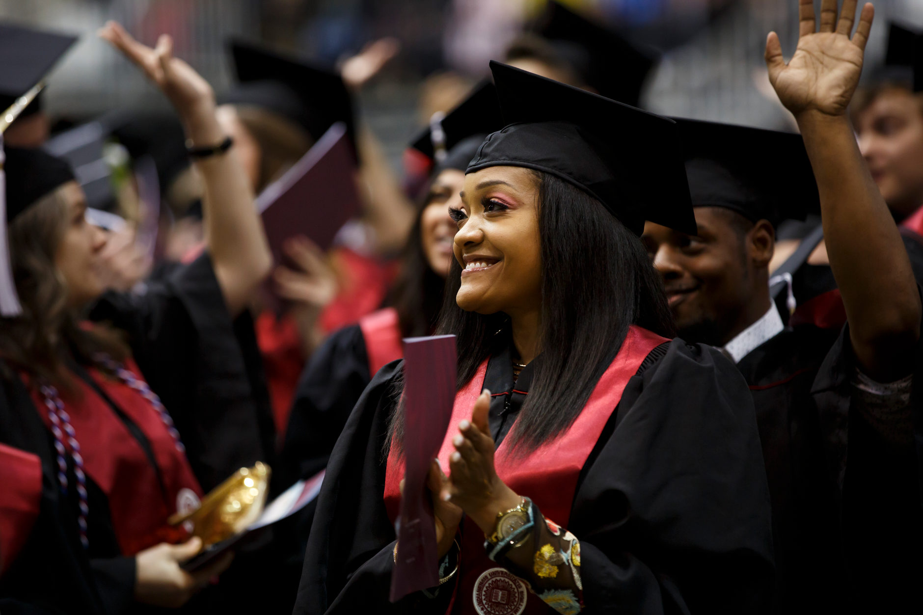 A graduate applauds her family in the audience during the IU Northwest Commencement at the Genesis Convention Center on Thursday, May 9, 2019. (James Brosher/Indiana University)