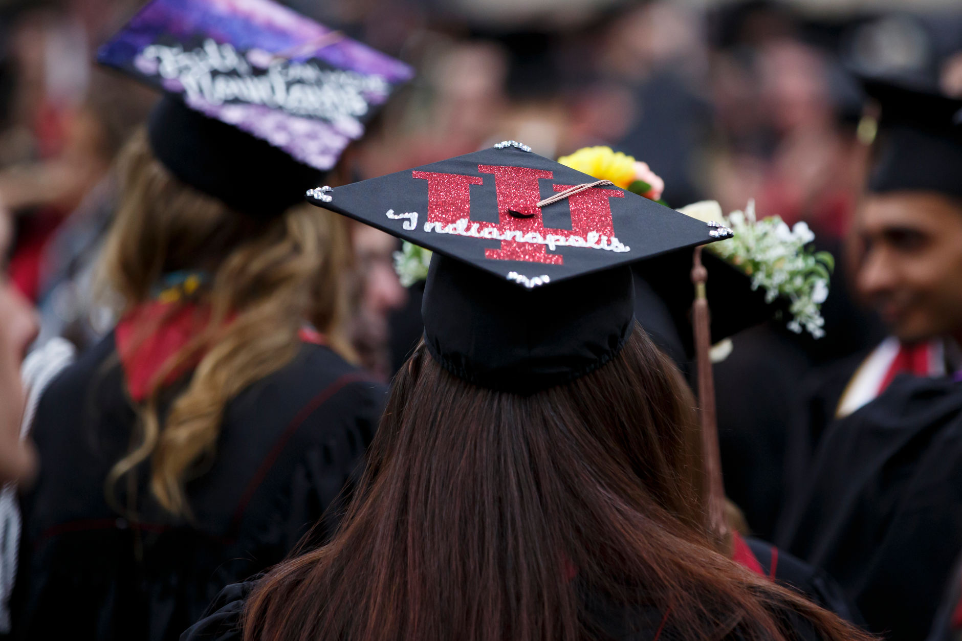 A graduate wears a decorated mortarboard before the IUPUI Commencement at Lucas Oil Stadium on Saturday, May 11, 2019. (James Brosher/Indiana University)