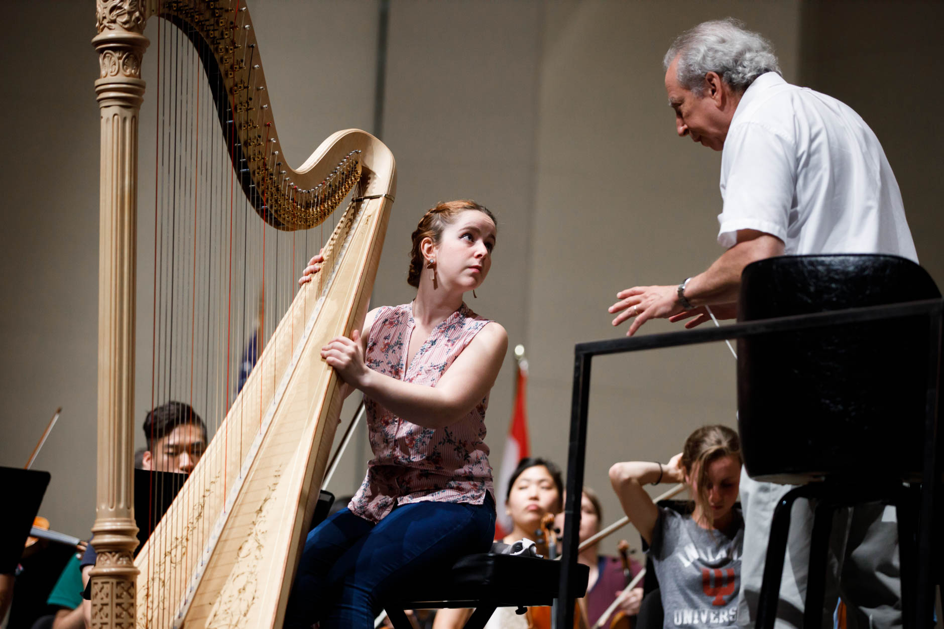 Melanie Laurent from France speaks with conductor Arthur Fagen during an orchestra rehearsal for the Final Stage concert at the 11th USA International Harp Competition at Indiana University in Bloomington, Indiana on Friday, July 12, 2019. (Photo by James Brosher)