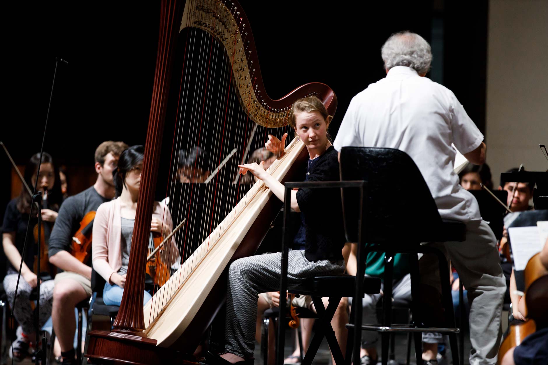 Mathilde Wauters from Belgium speaks with conductor Arthur Fagen during an orchestra rehearsal for the Final Stage concert at the 11th USA International Harp Competition at Indiana University in Bloomington, Indiana on Friday, July 12, 2019. (Photo by James Brosher)
