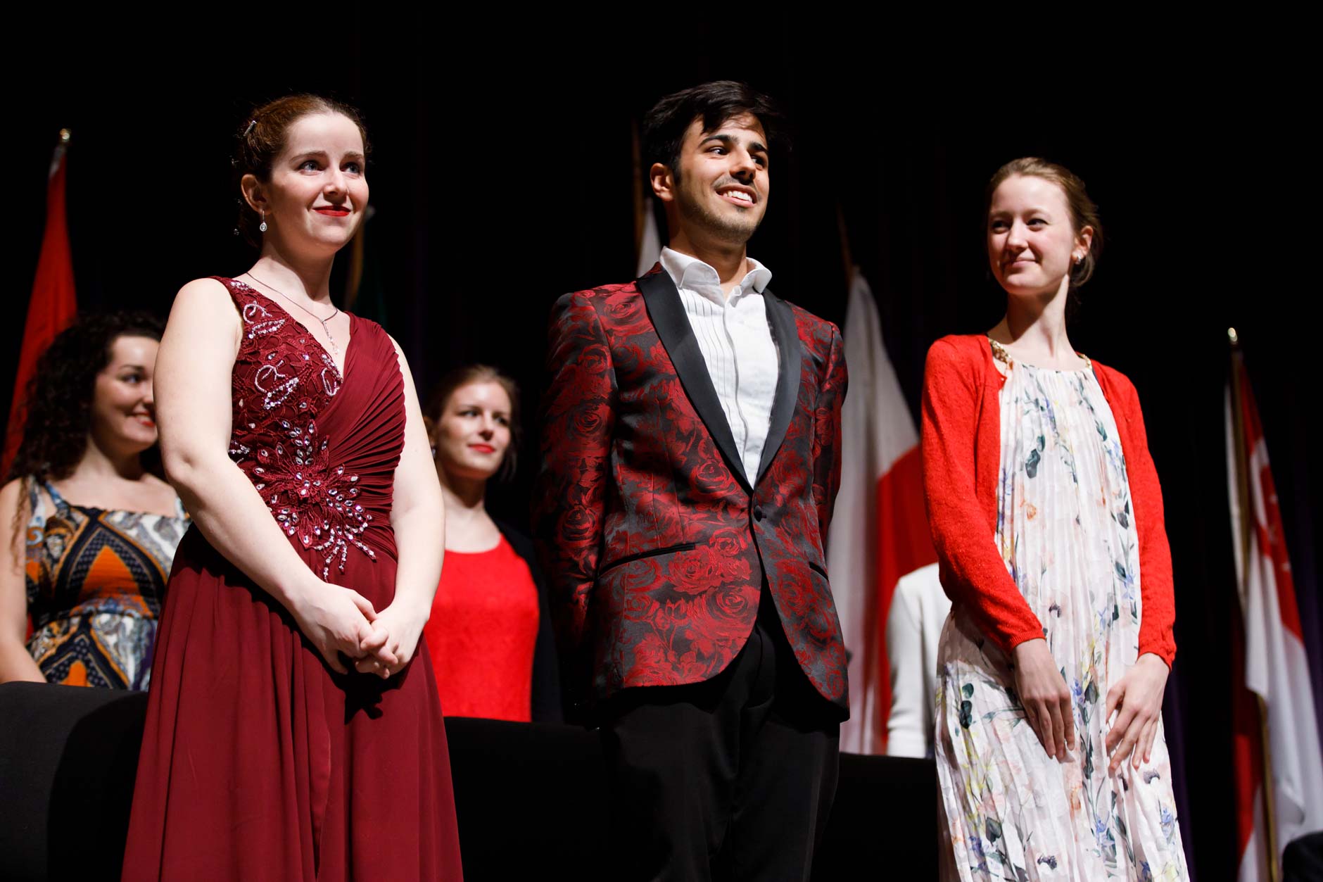 Stage IV finalists Melanie Laurent from France, left, Valerio Lisci from Italy and Mathilde Wauters from Belgium stand for recognition at the awards ceremony of the 11th USA International Harp Competition at Indiana University in Bloomington, Indiana on Saturday, July 13, 2019. (Photo by James Brosher)