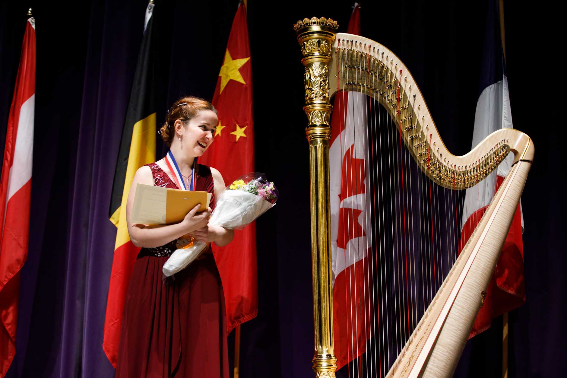 First prize winner Melanie Laurent from France receives the Lyon and Healy Concert Grand Harp during the awards ceremony of the 11th USA International Harp Competition at Indiana University in Bloomington, Indiana on Saturday, July 13, 2019. (Photo by James Brosher)
