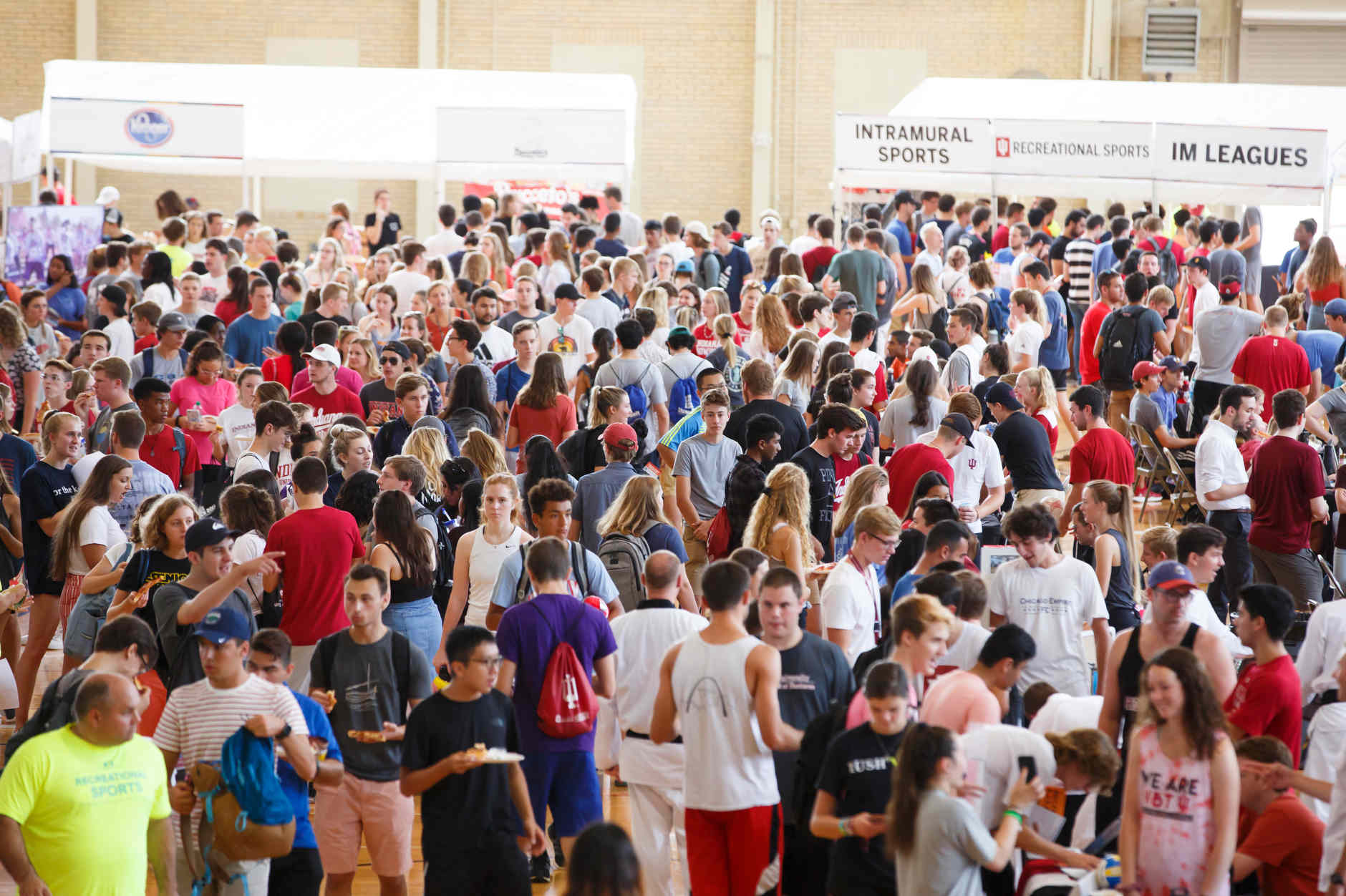 Students walk past booths during RecFest in the Intramural Center at IU Bloomington on Friday, Aug. 23, 2019. (James Brosher/Indiana University)