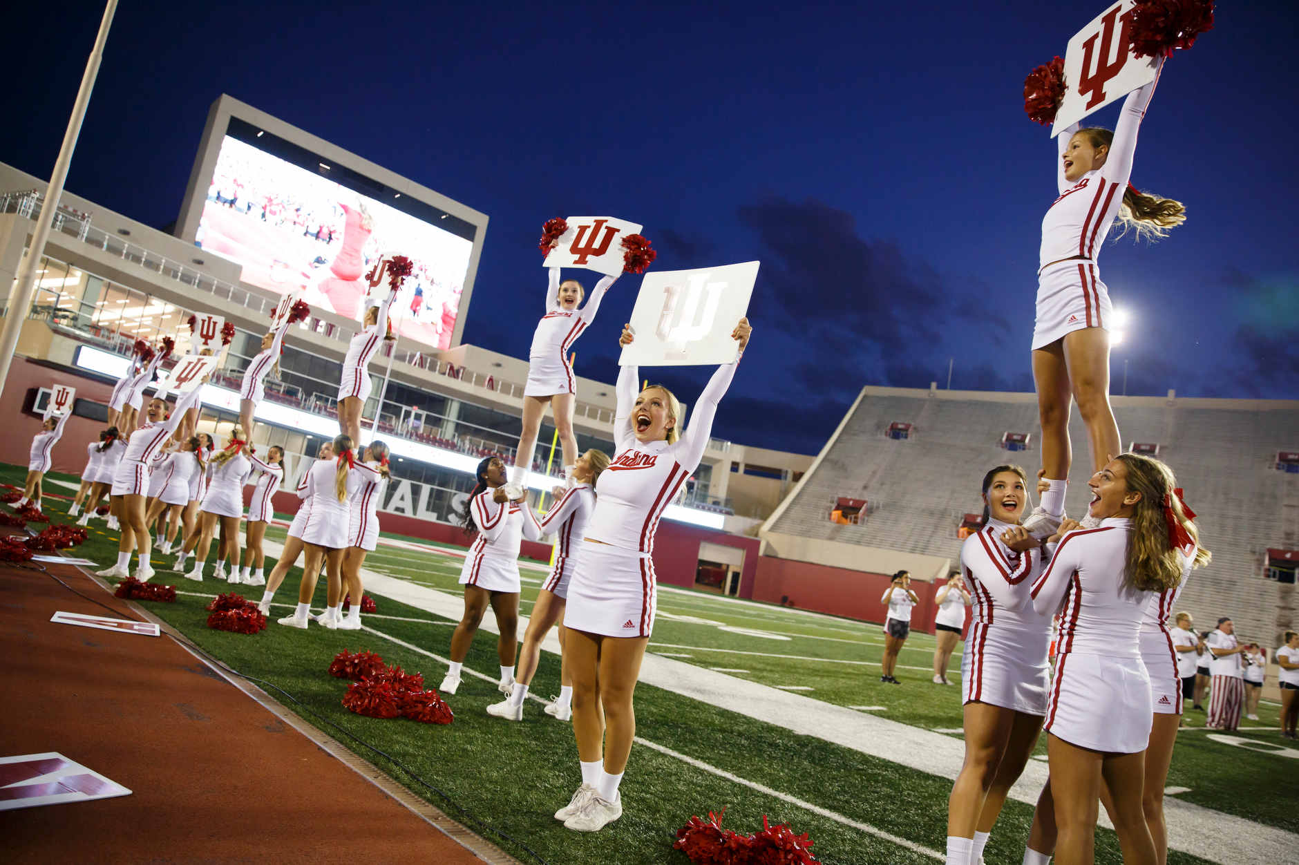 Indiana University cheerleaders teach the crowd a cheer during the Traditions and Spirit of IU at Memorial Stadium on Friday, Aug. 23, 2019. (James Brosher/Indiana University)