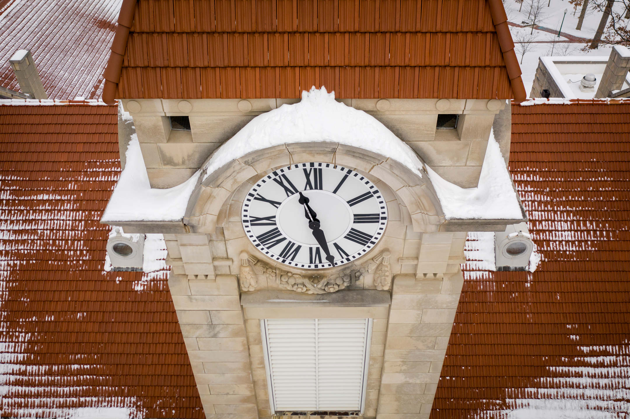 Snow clings to limestone features on the Student Building clock tower at Indiana University Bloomington on Friday, Feb. 12, 2021.