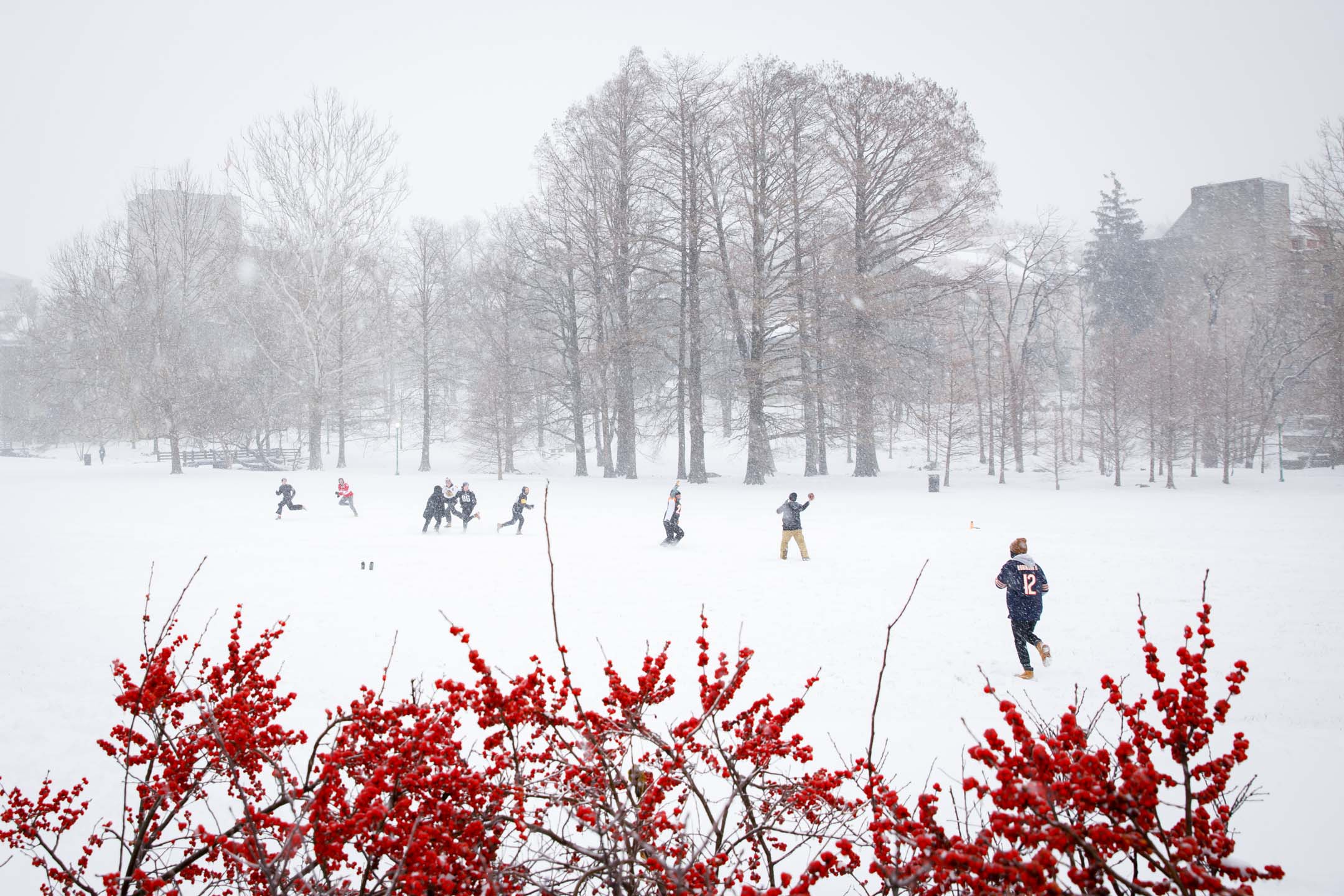 Students play football in the snow in Dunn Meadow at Indiana University Bloomington on Thursday, Feb. 3, 2022. (James Brosher/Indiana University)