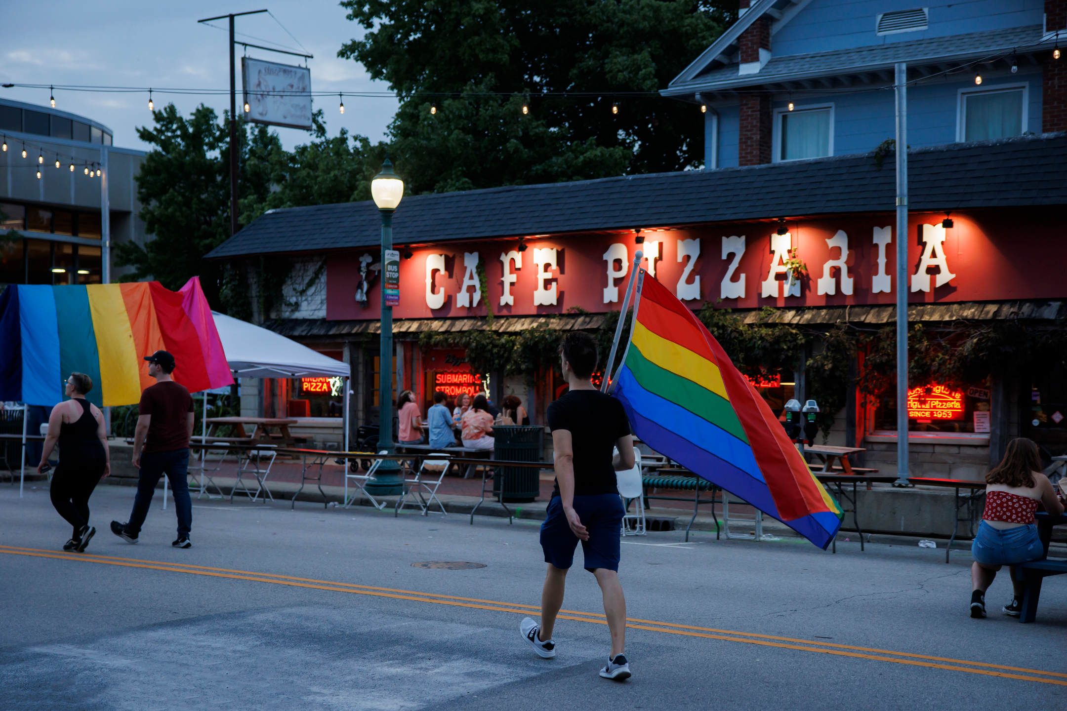 A person carries a pride flag during Bloomington Pridefest on Kirkwood Avenue on Saturday, Aug. 26, 2023. (James Brosher/Indiana University)